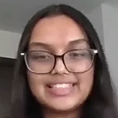 Meghan, smiling, on a video call